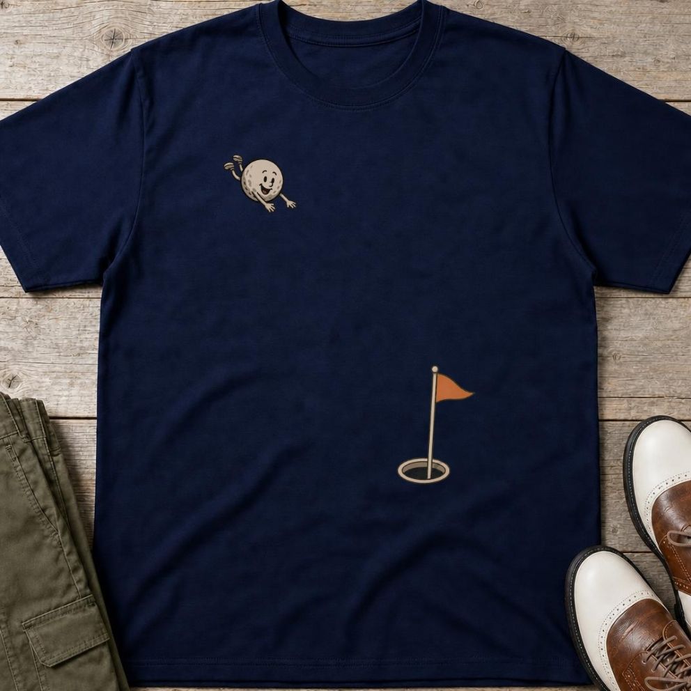 Flying Golf Ball T-Shirt in Navy lying on a plain floor. T-shirt is a unisex cut and 100 per cent cotton.