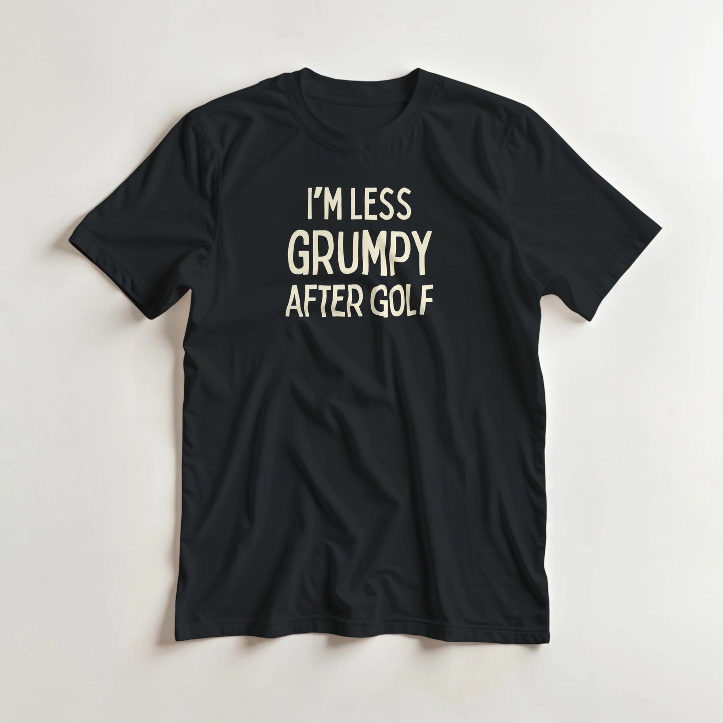 I'm Less Grumpy After Golf T-Shirt in Black lying on a plain floor. T-shirt is a unisex cut and 100 per cent cotton.