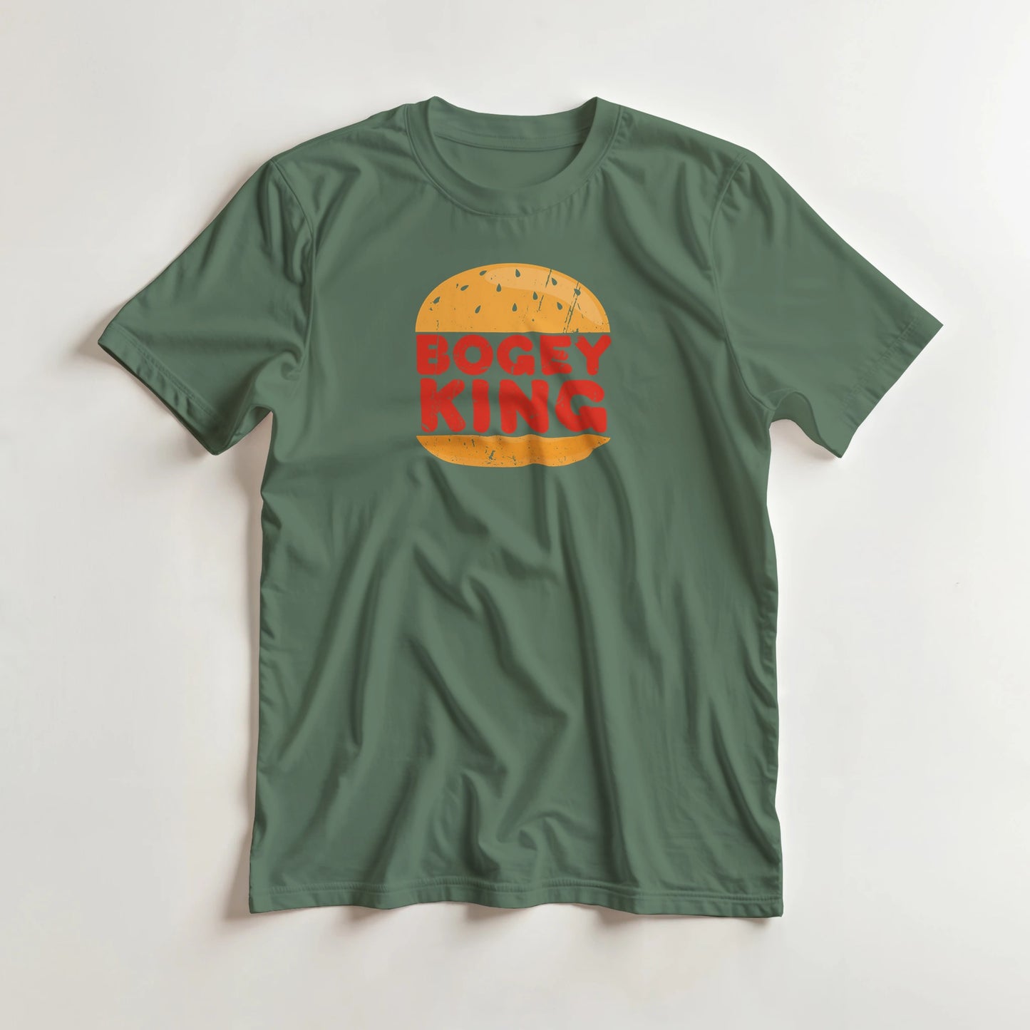 Bogey King T-Shirt in Military Green lying on a plain floor. T-shirt is a unisex cut and 100 per cent cotton.
