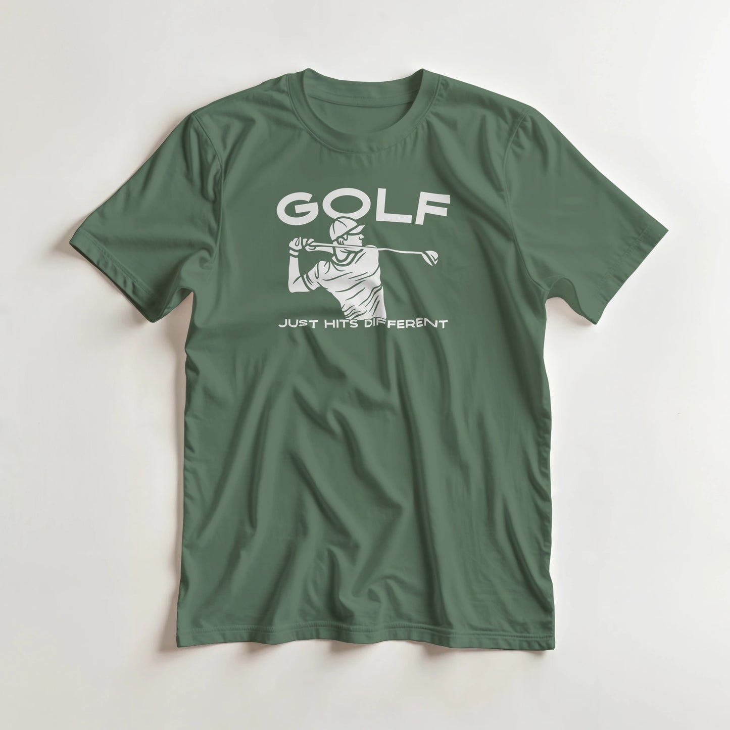 Hits Different T-Shirt in Military Green 2XL lying on a plain floor. T-shirt is a unisex cut and 100 per cent cotton.