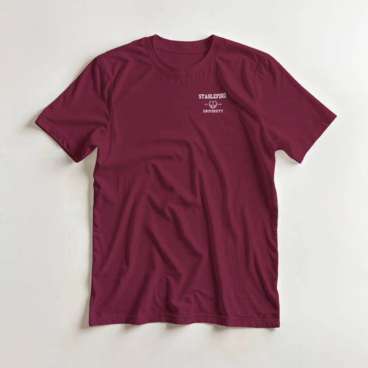 Stableford (Pocket) T-Shirt in Maroon S lying on a plain floor. T-shirt is a unisex cut and 100 per cent cotton.
