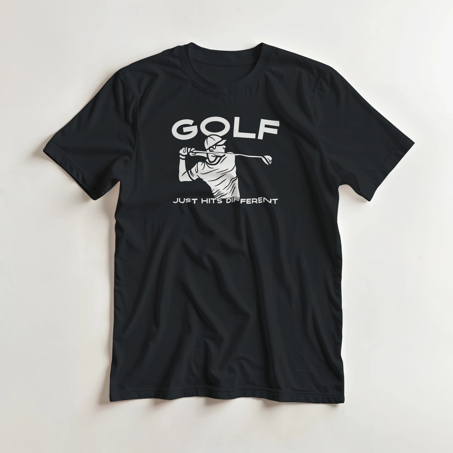 Hits Different T-Shirt in Black L lying on a plain floor. T-shirt is a unisex cut and 100 per cent cotton.