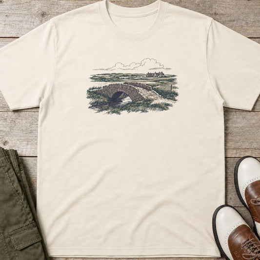 The Burn T-Shirt in Natural lying on a plain floor. T-shirt is a unisex cut and 100 per cent cotton.