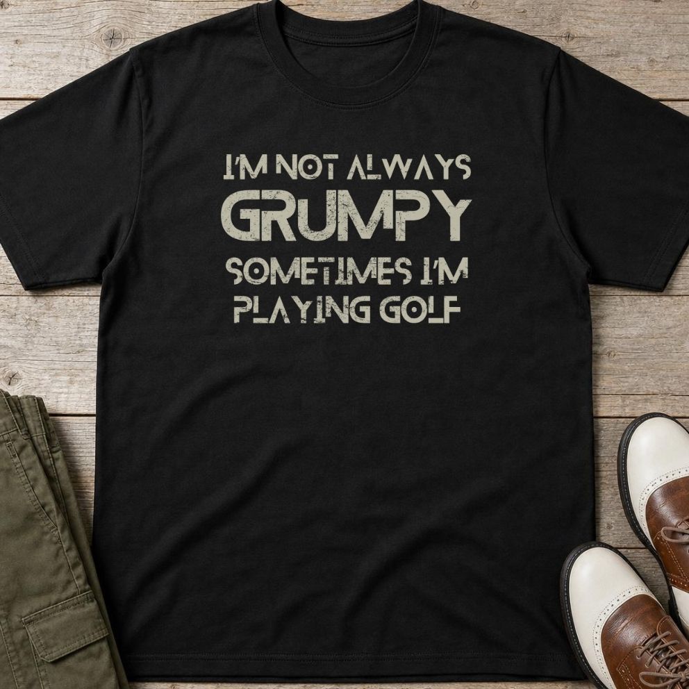 Grumpy Golf T-Shirt in Black lying on a plain floor. T-shirt is a unisex cut and 100 per cent cotton.
