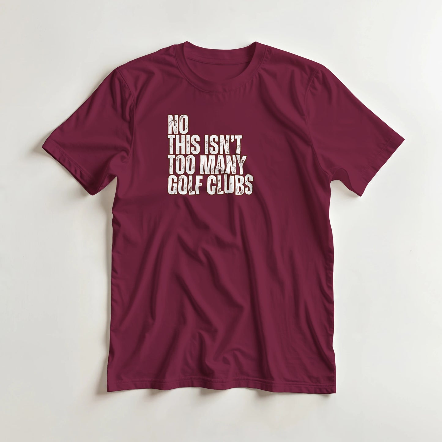 Too Many T-Shirt in Maroon XL lying on a plain floor. T-shirt is a unisex cut and 100 per cent cotton.