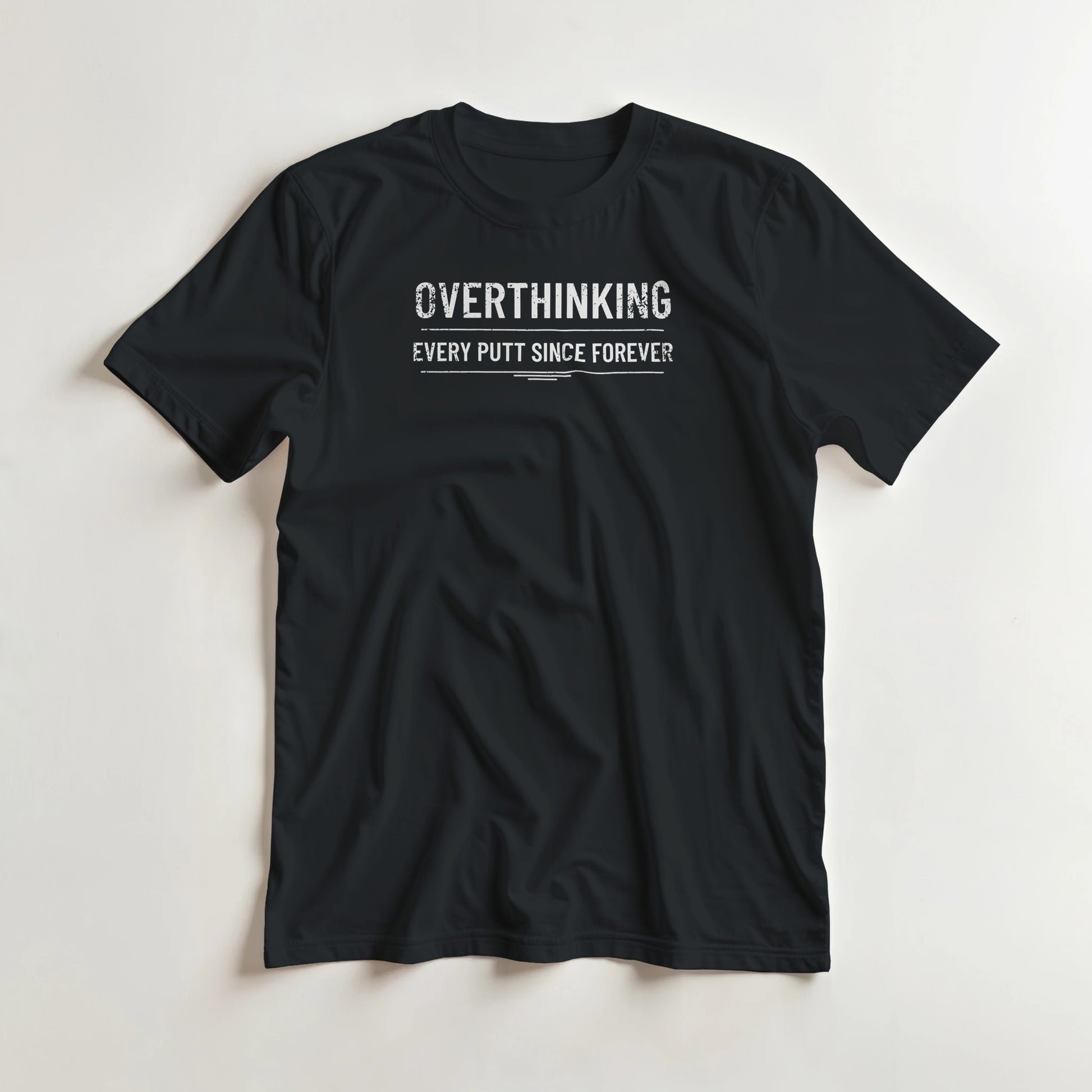 Every Putt T-Shirt in Black lying on a plain floor. T-shirt is a unisex cut and 100 per cent cotton.