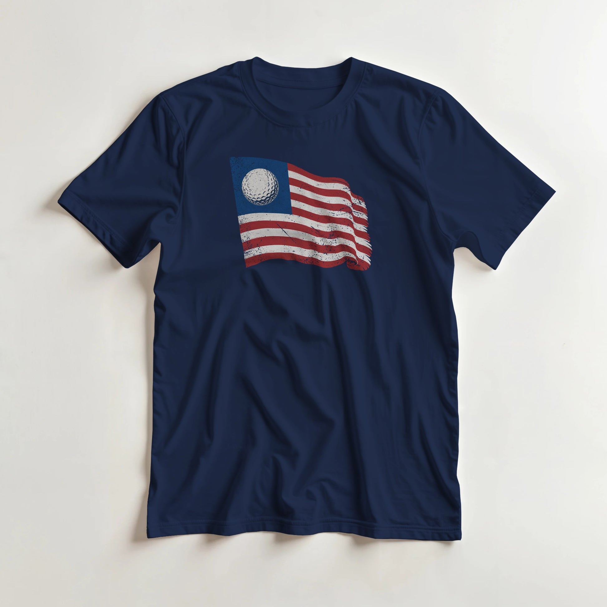 Golf Flag T-Shirt in Navy lying on a plain floor. T-shirt is a unisex cut and 100 per cent cotton.