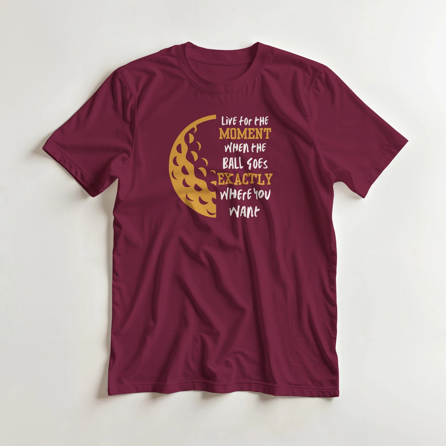 The Moment T-Shirt in Maroon lying on a plain floor. T-shirt is a unisex cut and 100 per cent cotton.