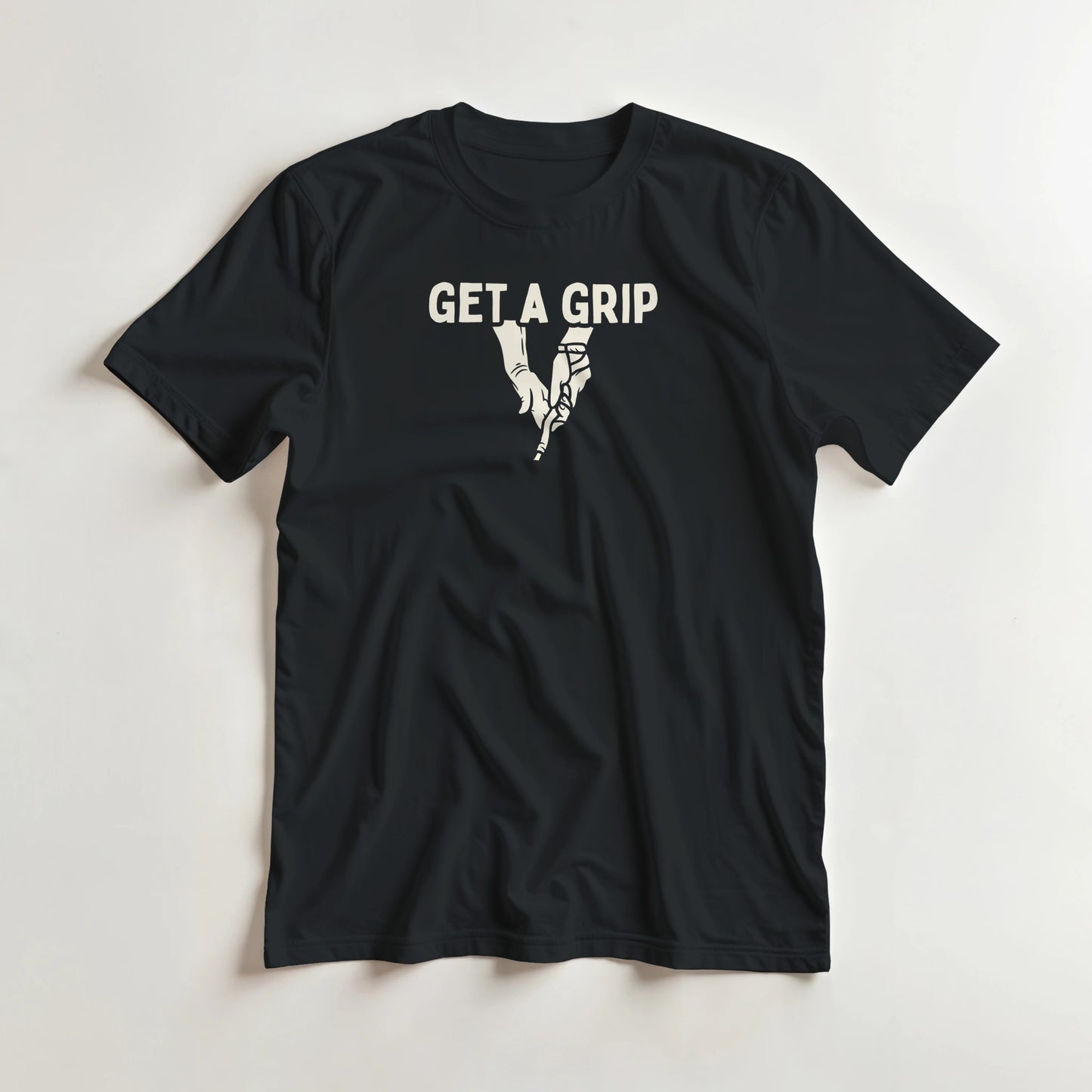 Get A Grip T-Shirt in Black M lying on a plain floor. T-shirt is a unisex cut and 100 per cent cotton.