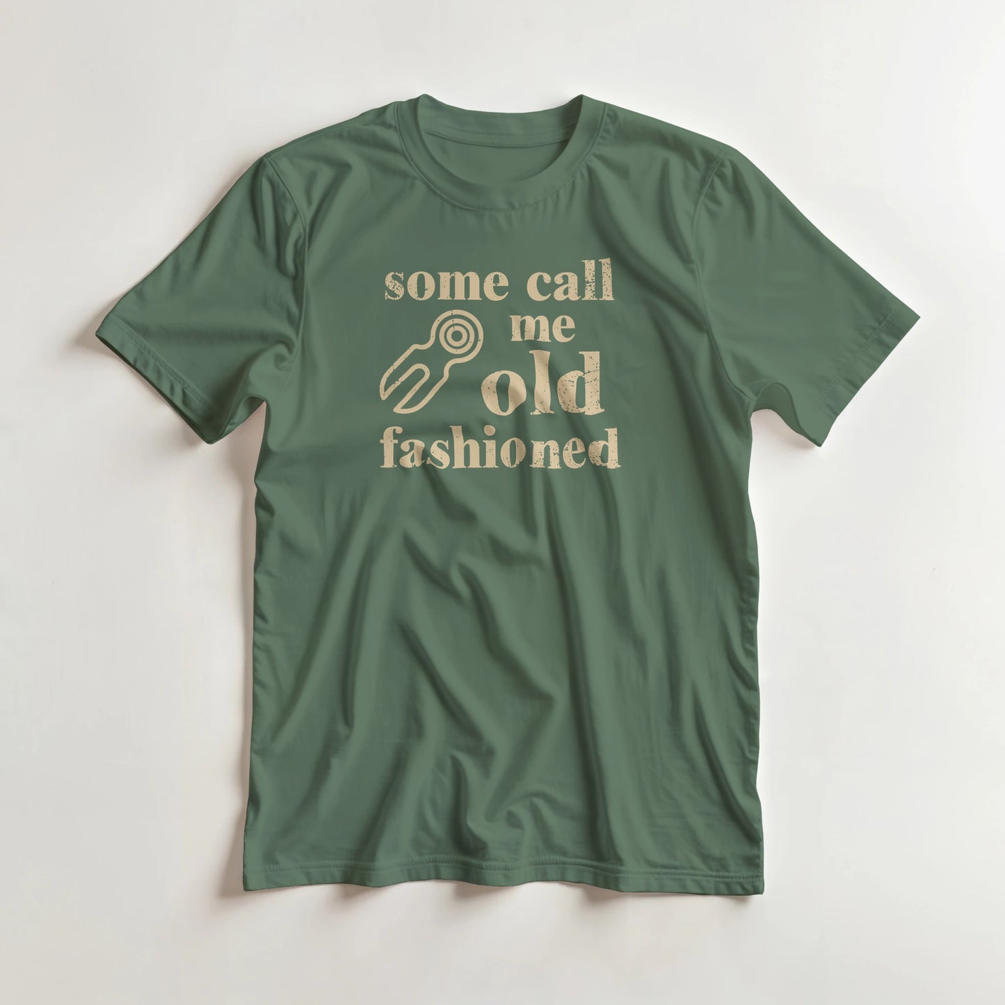 Old Fashioned T-Shirt in Military Green M lying on a plain floor. T-shirt is a unisex cut and 100 per cent cotton.