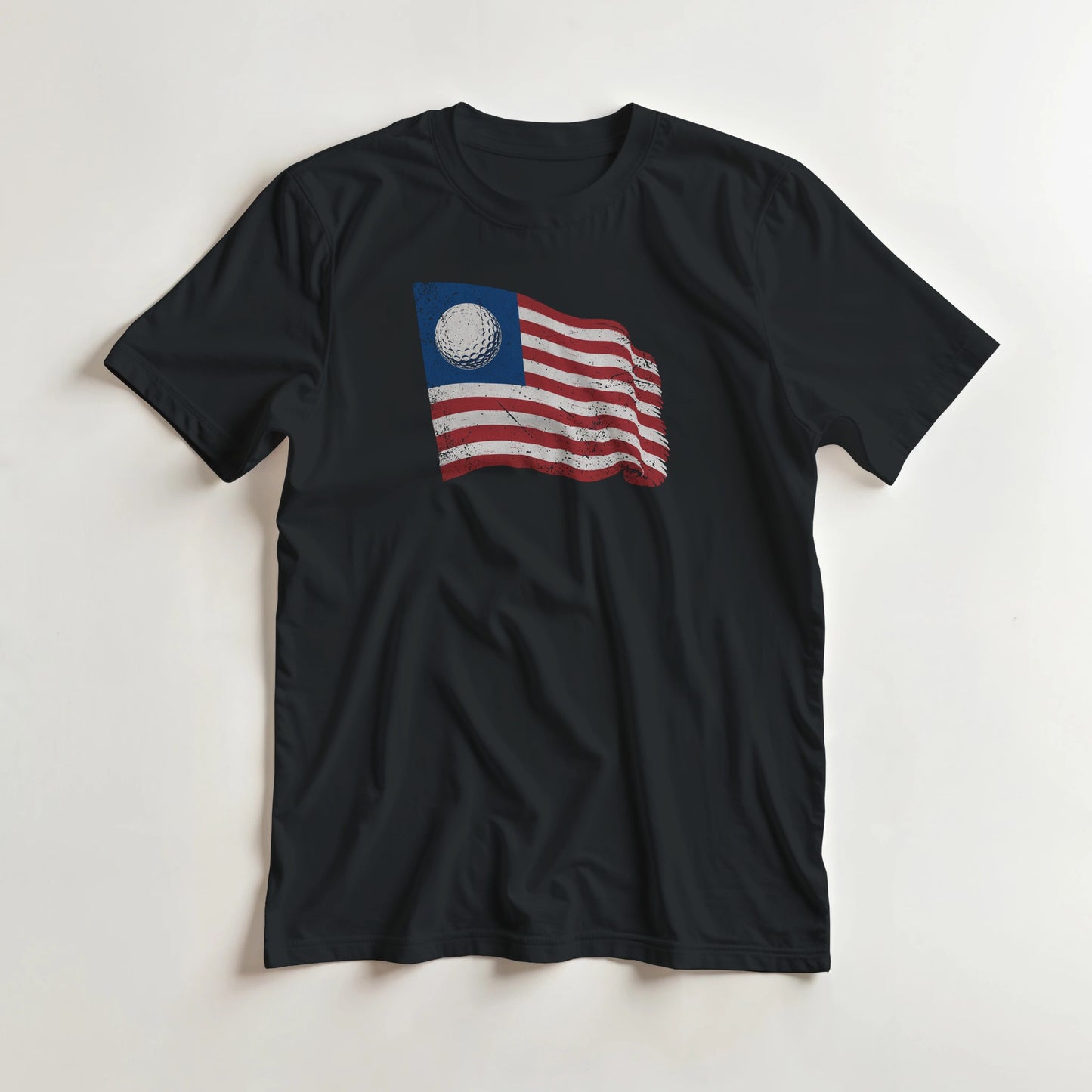 Golf Flag T-Shirt in Black lying on a plain floor. T-shirt is a unisex cut and 100 per cent cotton.