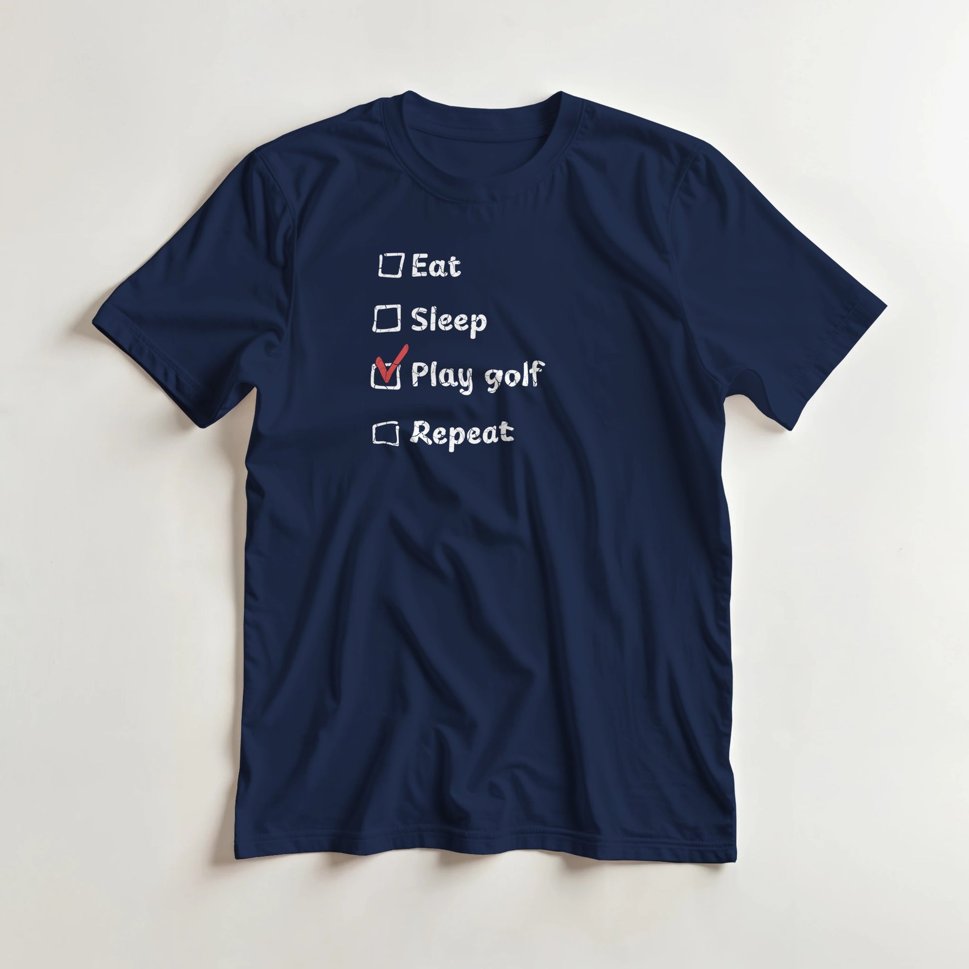 Golf Repeat T-Shirt in Navy lying on a plain floor. T-shirt is a unisex cut and 100 per cent cotton.