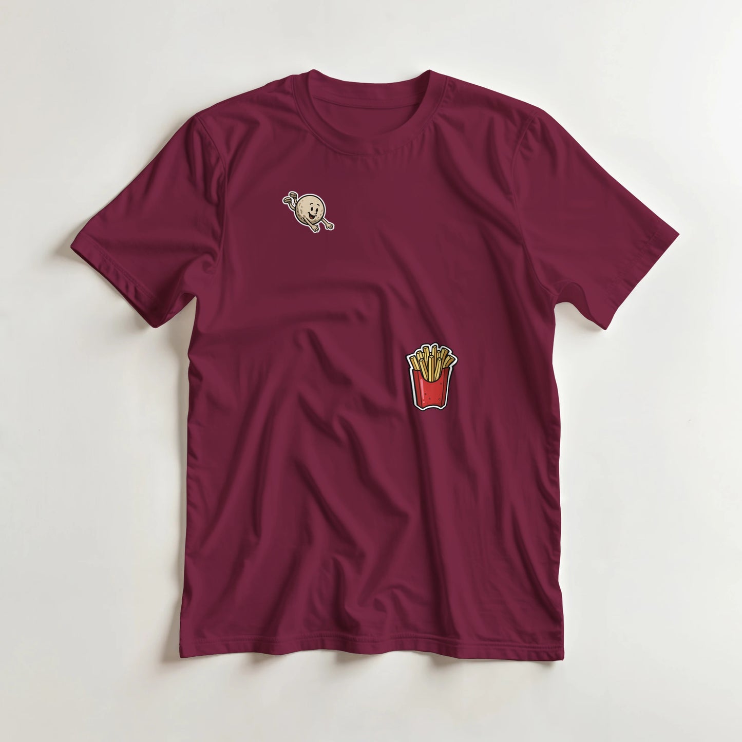 Flying Golf & Fries T-Shirt in Maroon lying on a plain floor. T-shirt is a unisex cut and 100 per cent cotton.