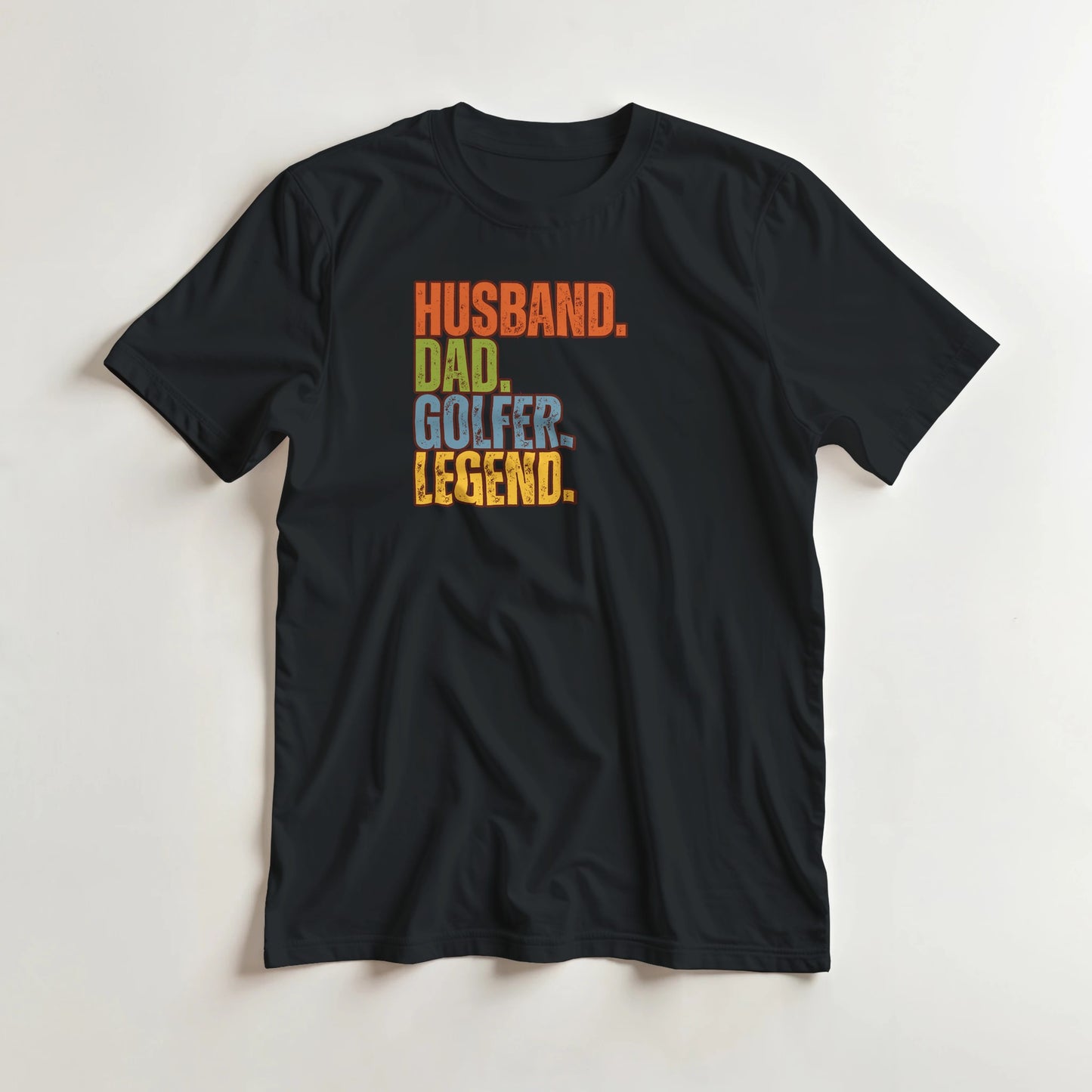 Husband Dad T-Shirt in Black lying on a plain floor. T-shirt is a unisex cut and 100 per cent cotton.
