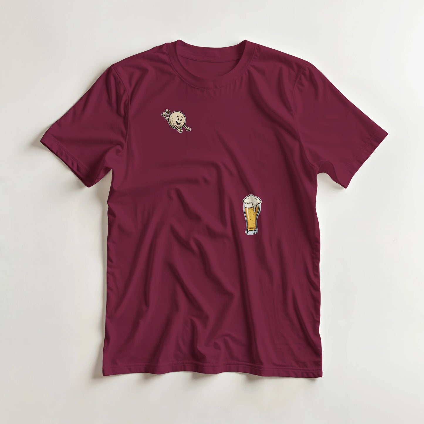 Flying Golf & Beer T-Shirt in Maroon lying on a plain floor. T-shirt is a unisex cut and 100 per cent cotton.