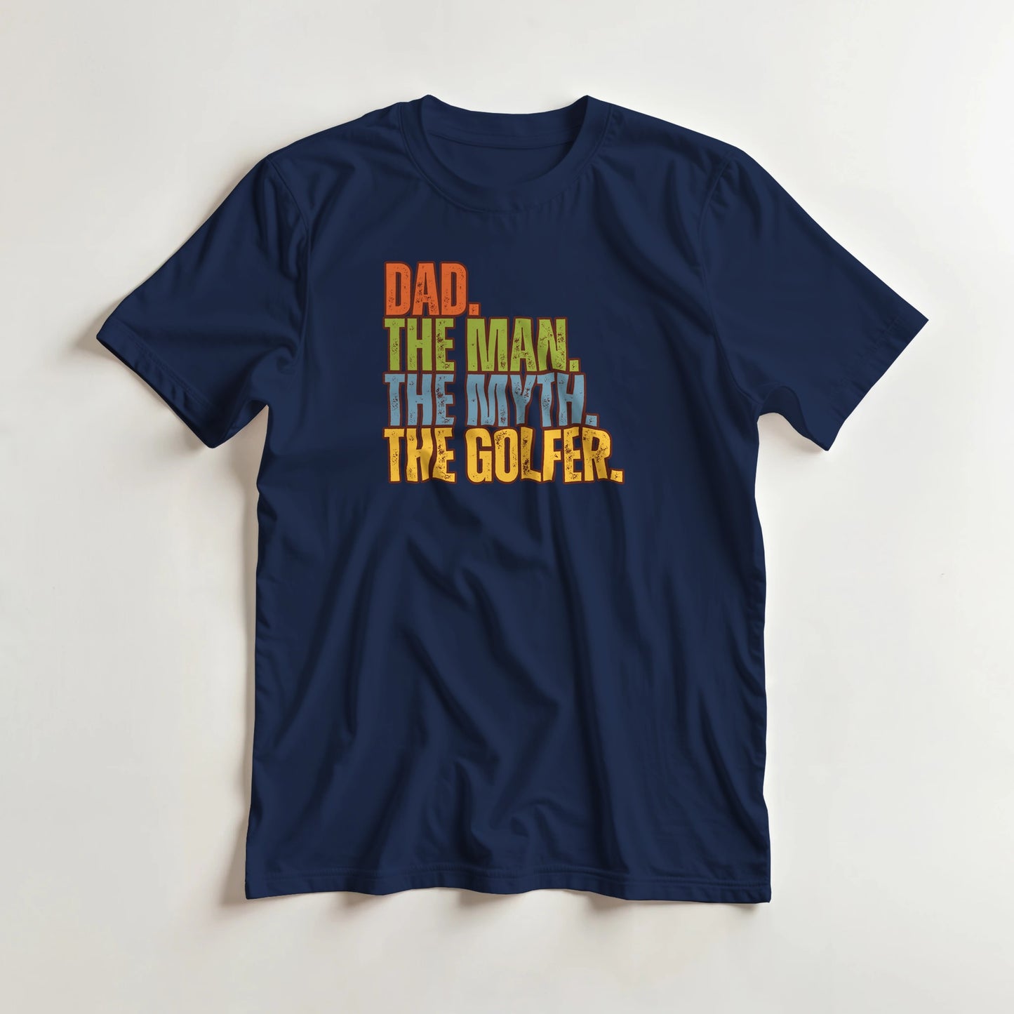 Dad The Legend Golfer T-Shirt in Navy S lying on a plain floor. T-shirt is a unisex cut and 100 per cent cotton.