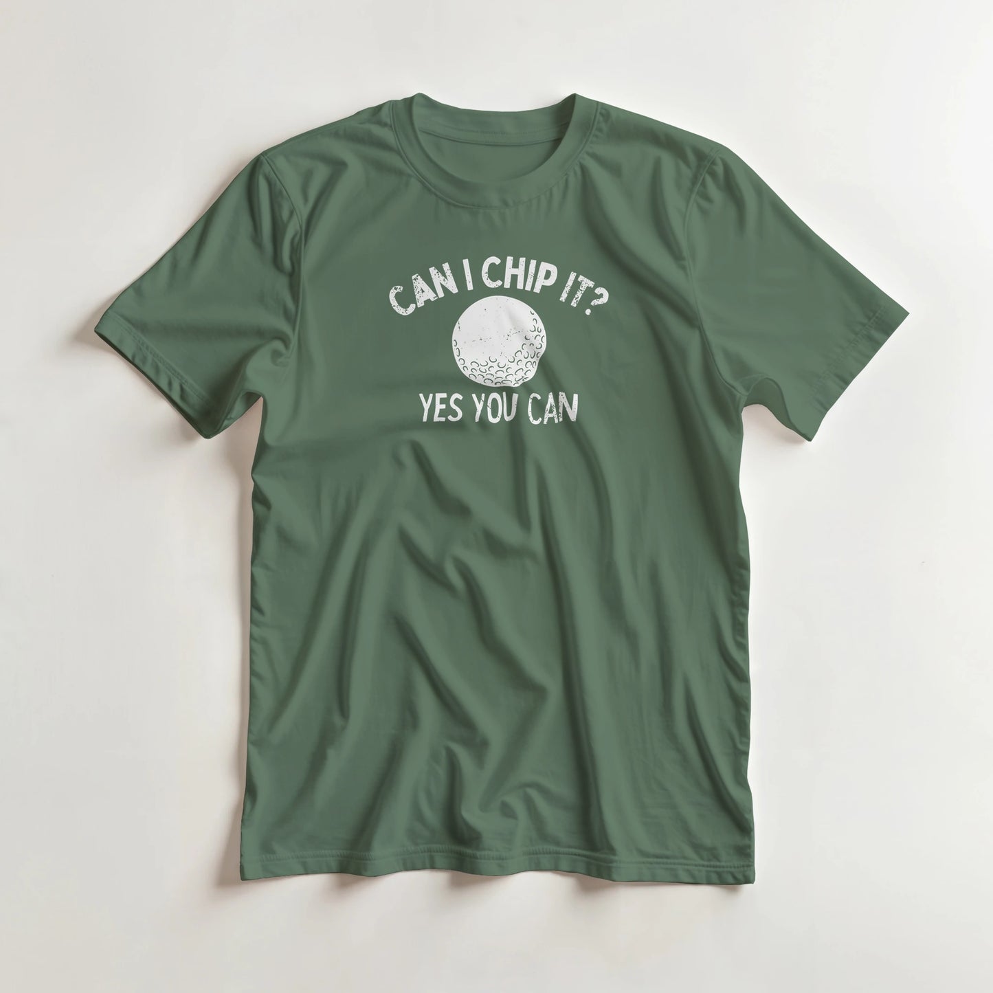 Can I Chip It T-Shirt in Military Green lying on a plain floor. T-shirt is a unisex cut and 100 per cent cotton.