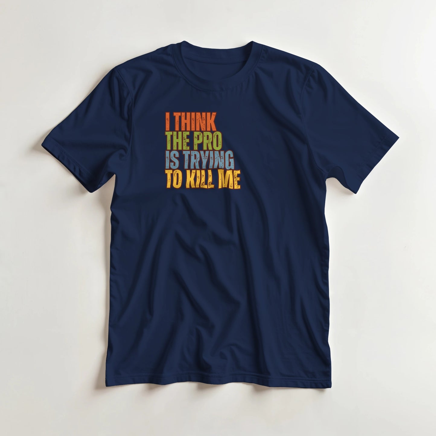 The Pro T-Shirt in Navy lying on a plain floor. T-shirt is a unisex cut and 100 per cent cotton.