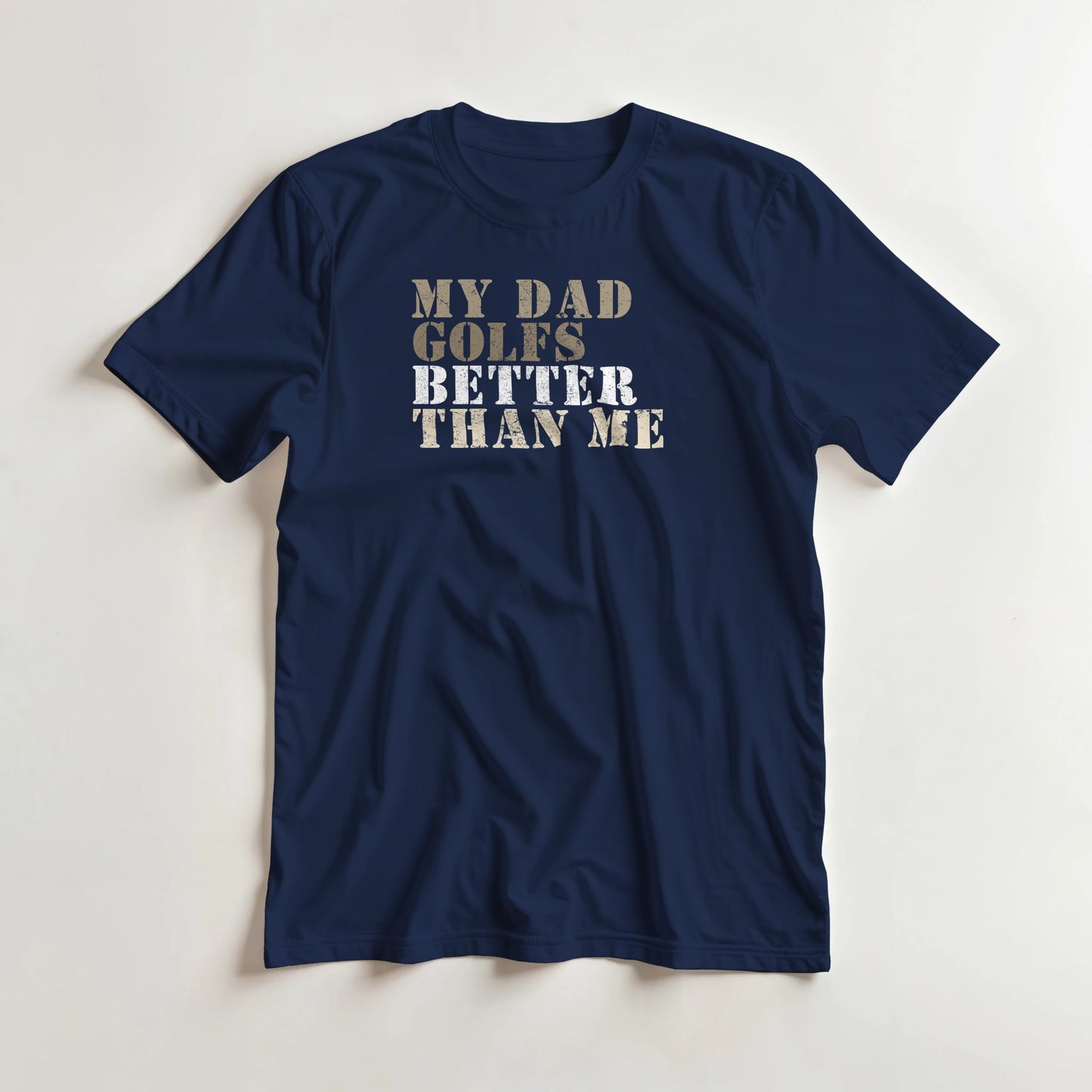 My Dad Golfs T-Shirt in Navy lying on a plain floor. T-shirt is a unisex cut and 100 per cent cotton.