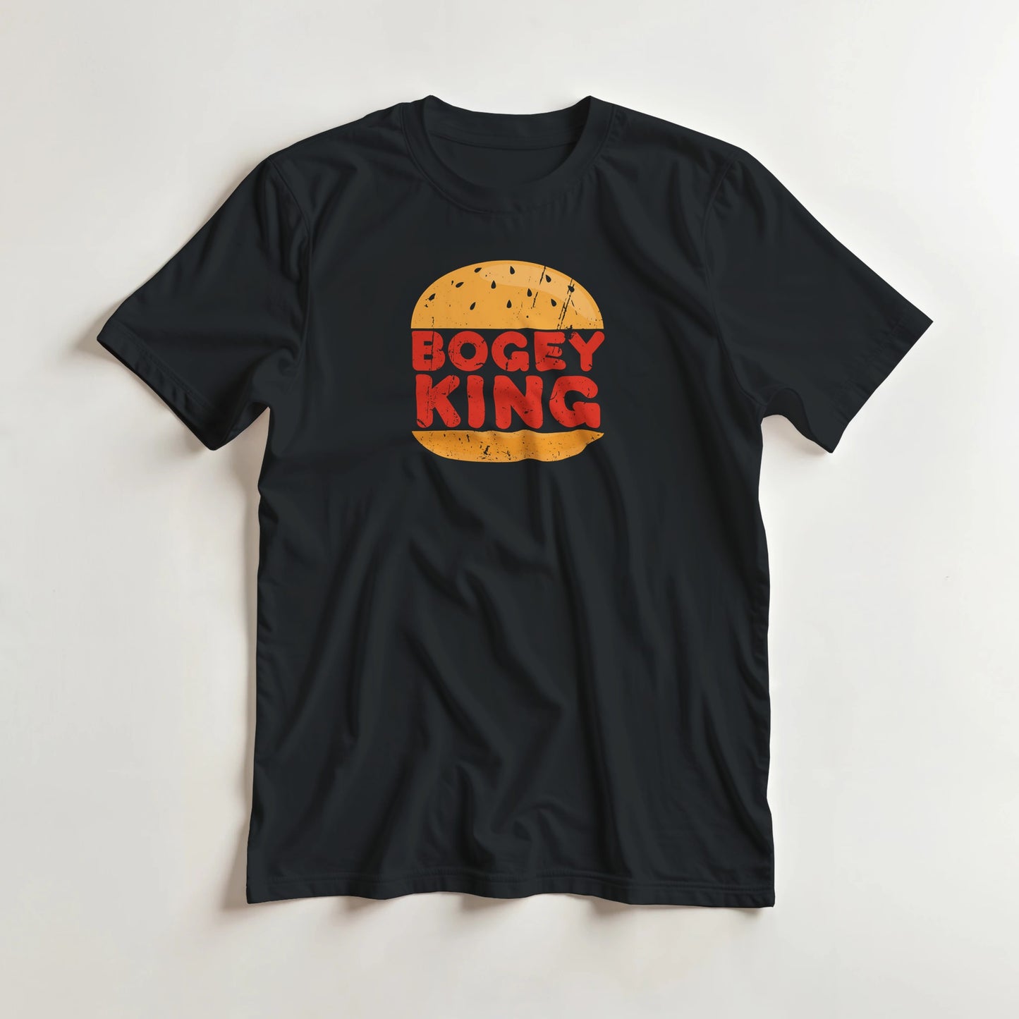Bogey King T-Shirt in Black lying on a plain floor. T-shirt is a unisex cut and 100 per cent cotton.