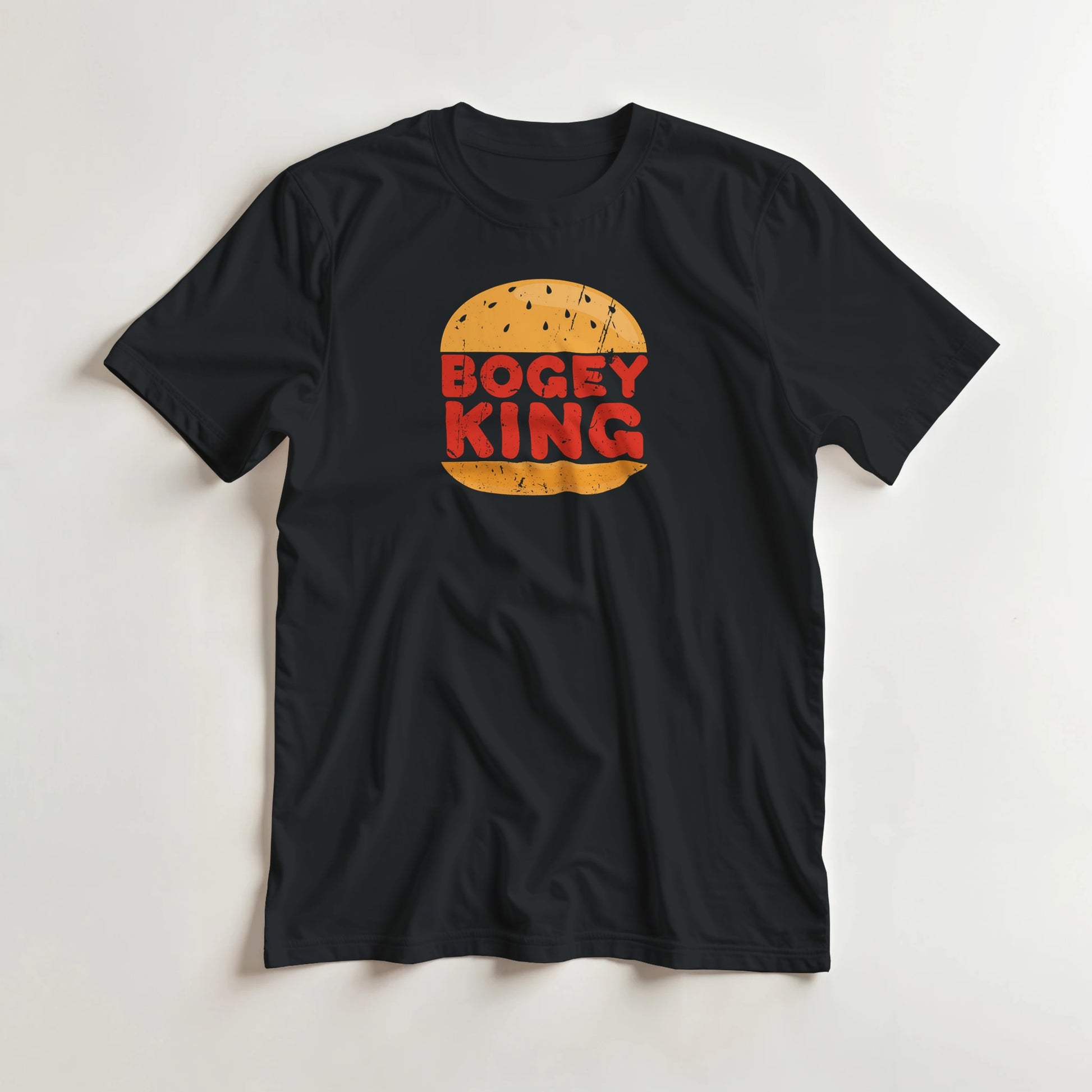 Bogey King T-Shirt in Black lying on a plain floor. T-shirt is a unisex cut and 100 per cent cotton.