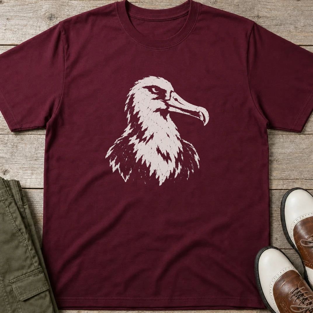 Albatross Block Print T-Shirt in Maroon lying on a plain floor. T-shirt is a unisex cut and 100 per cent cotton.