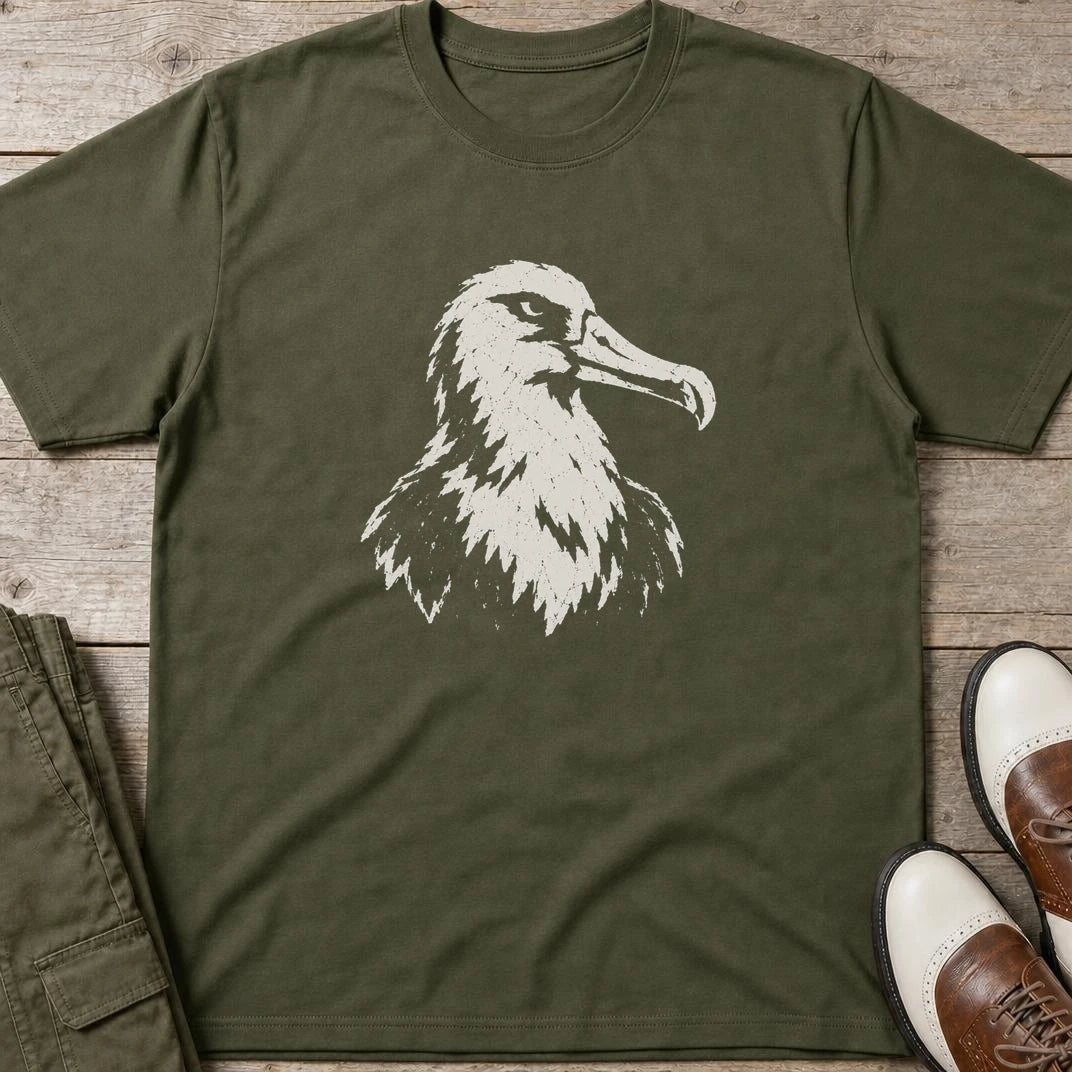 Albatross Block Print T-Shirt in Military Green lying on a plain floor. T-shirt is a unisex cut and 100 per cent cotton.