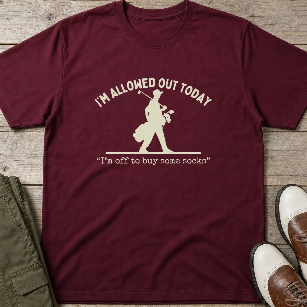 Allowed Out T-Shirt in Maroon lying on a plain floor. T-shirt is a unisex cut and 100 per cent cotton.
