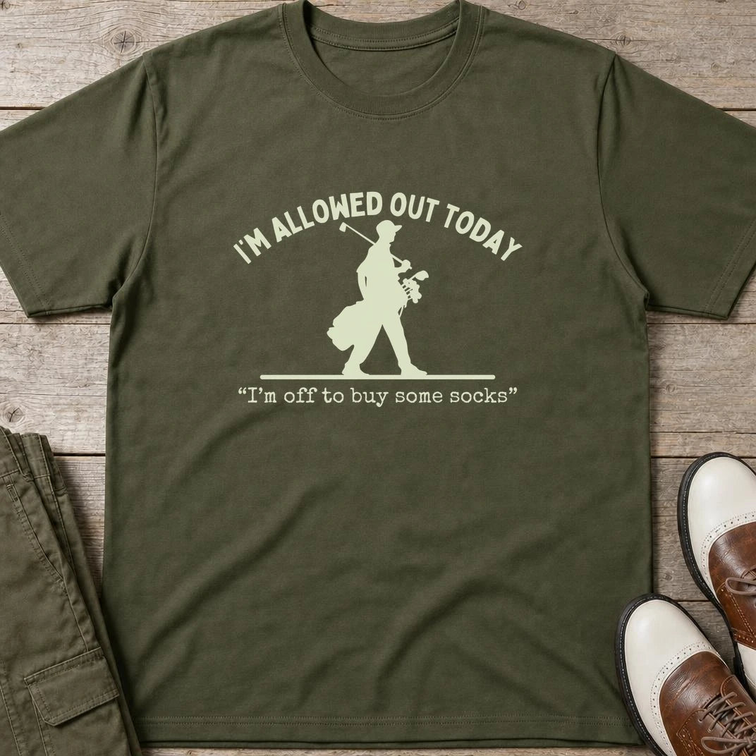 Allowed Out T-Shirt in Military Green lying on a plain floor. T-shirt is a unisex cut and 100 per cent cotton.