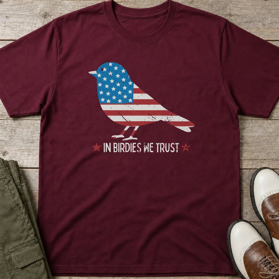 In Birdies We Trust T-Shirt in Maroon lying on a plain floor. T-shirt is a unisex cut and 100 per cent cotton.