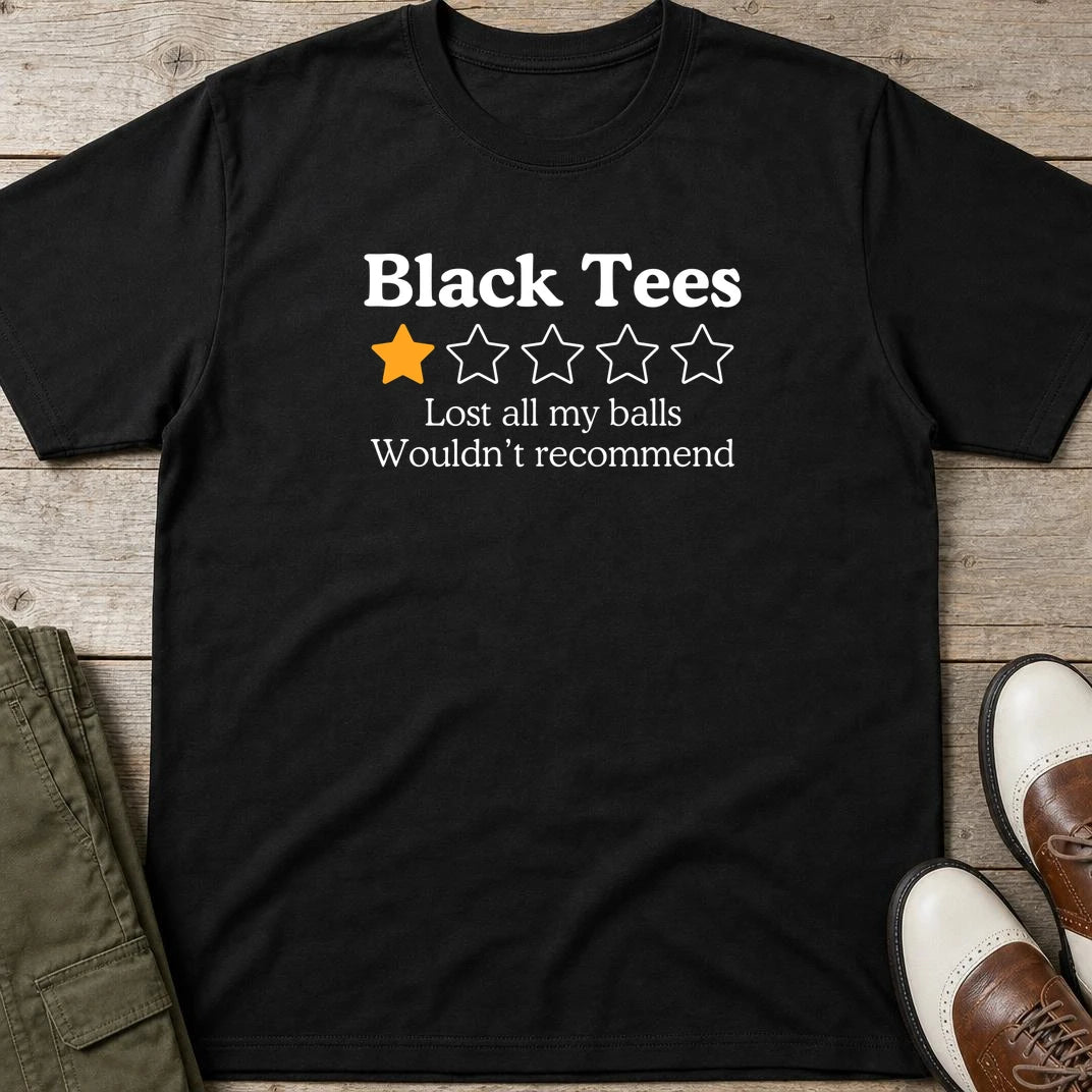 Black Tees T-Shirt in Black lying on a plain floor. T-shirt is a unisex cut and 100 per cent cotton.
