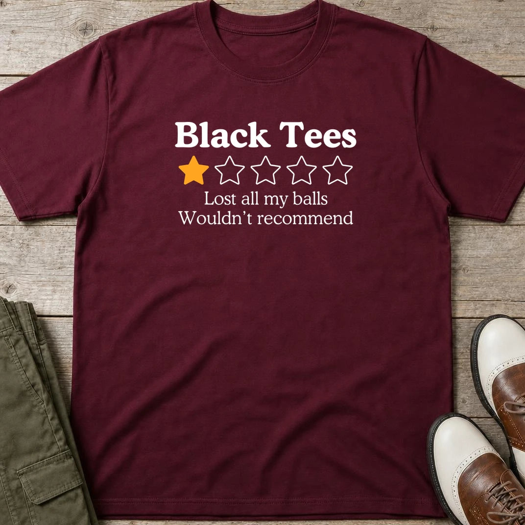 Black Tees T-Shirt in Maroon lying on a plain floor. T-shirt is a unisex cut and 100 per cent cotton.