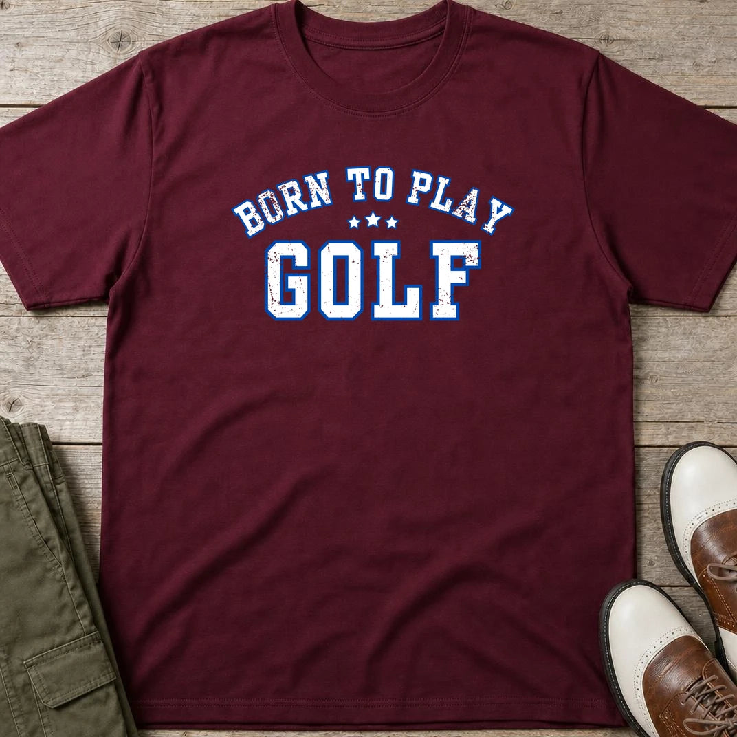 Born To Play Golf T-Shirt in Maroon lying on a plain floor. T-shirt is a unisex cut and 100 per cent cotton.