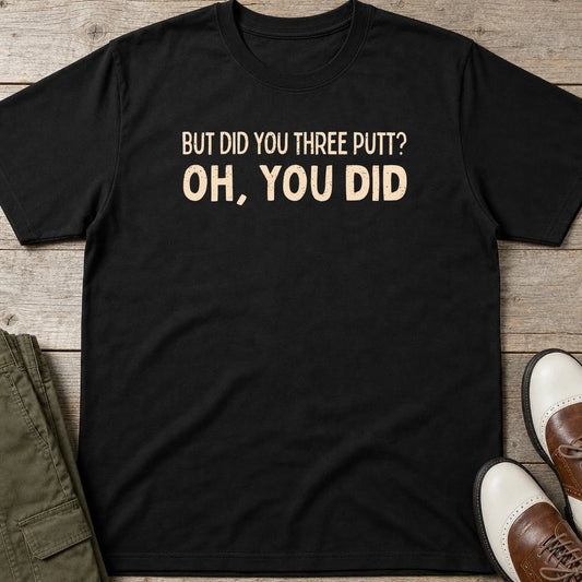 Did You Three Putt T-Shirt in Black lying on a plain floor. T-shirt is a unisex cut and 100 per cent cotton.
