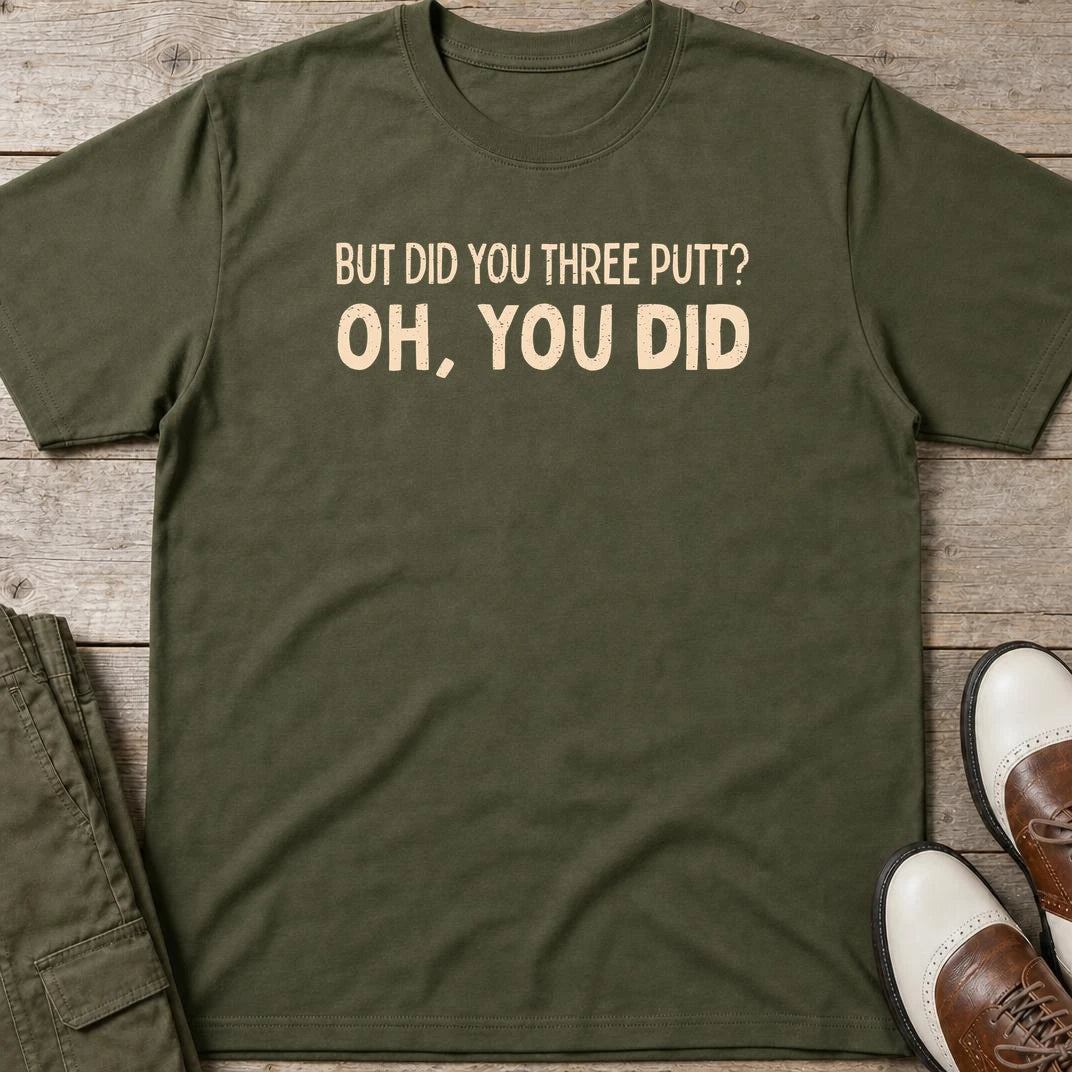 Did You Three Putt T-Shirt in Military Green lying on a plain floor. T-shirt is a unisex cut and 100 per cent cotton.