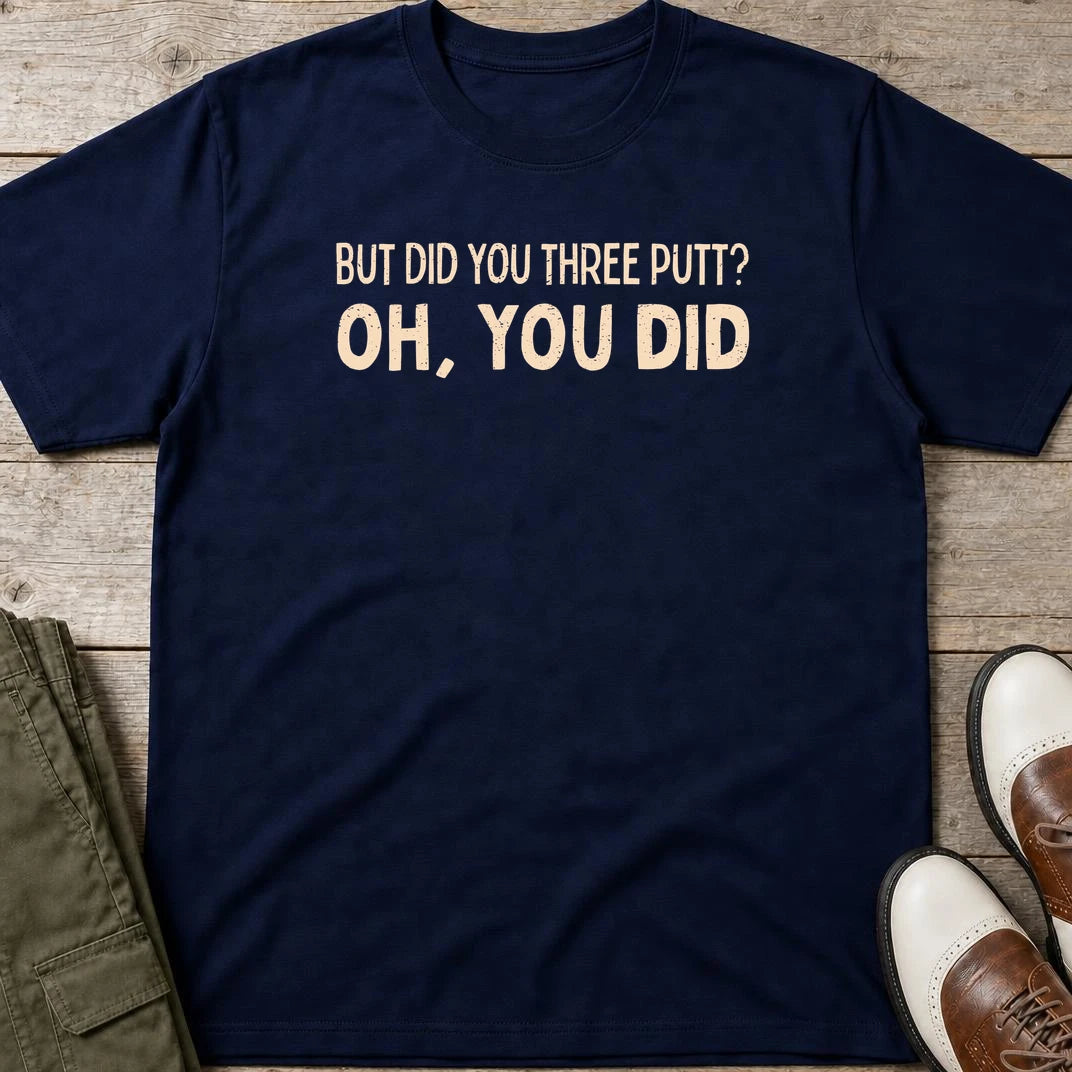 Did You Three Putt T-Shirt in Navy lying on a plain floor. T-shirt is a unisex cut and 100 per cent cotton.