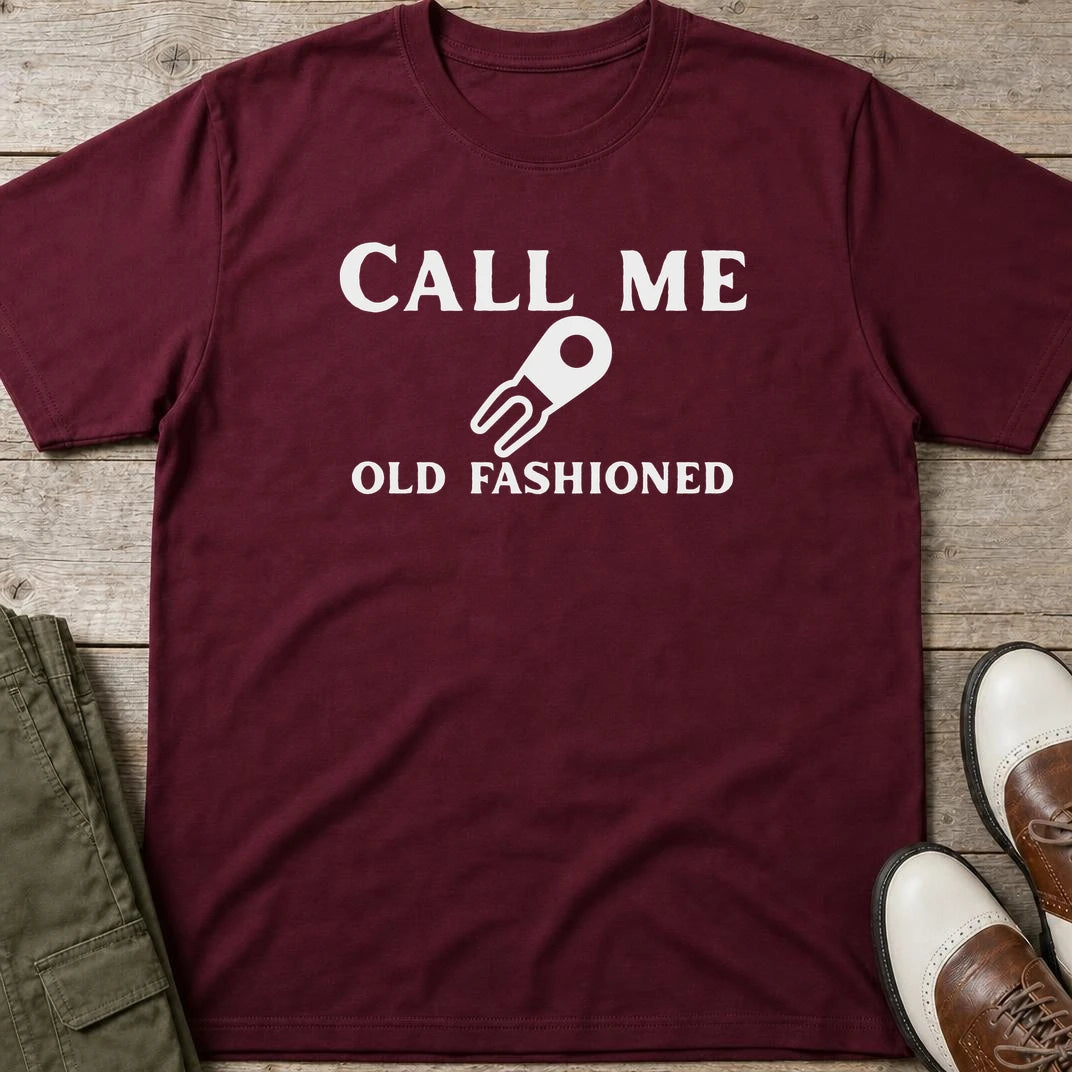 Call Me T-Shirt in Maroon lying on a plain floor. T-shirt is a unisex cut and 100 per cent cotton.