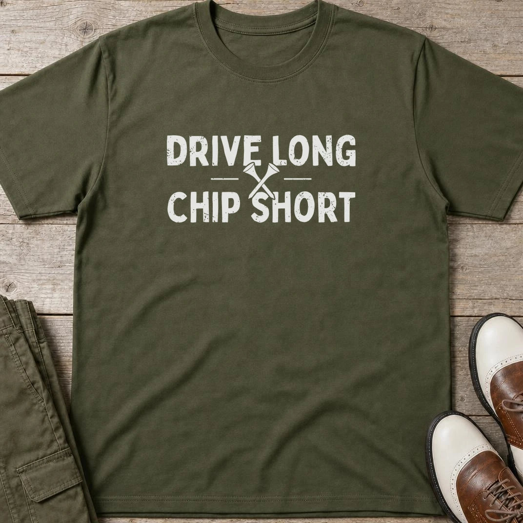 Chip Short T-Shirt in Military Green lying on a plain floor. T-shirt is a unisex cut and 100 per cent cotton.