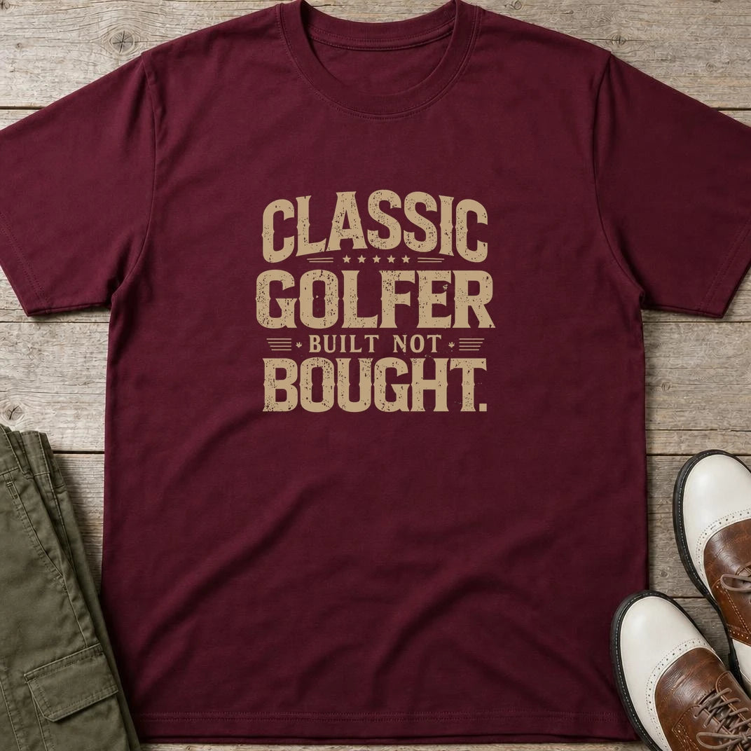 Built Not Bought T-Shirt in Maroon lying on a plain floor. T-shirt is a unisex cut and 100 per cent cotton.