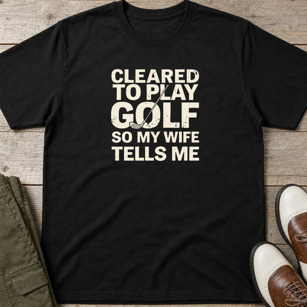 Cleared T-Shirt in Black lying on a plain floor. T-shirt is a unisex cut and 100 per cent cotton.