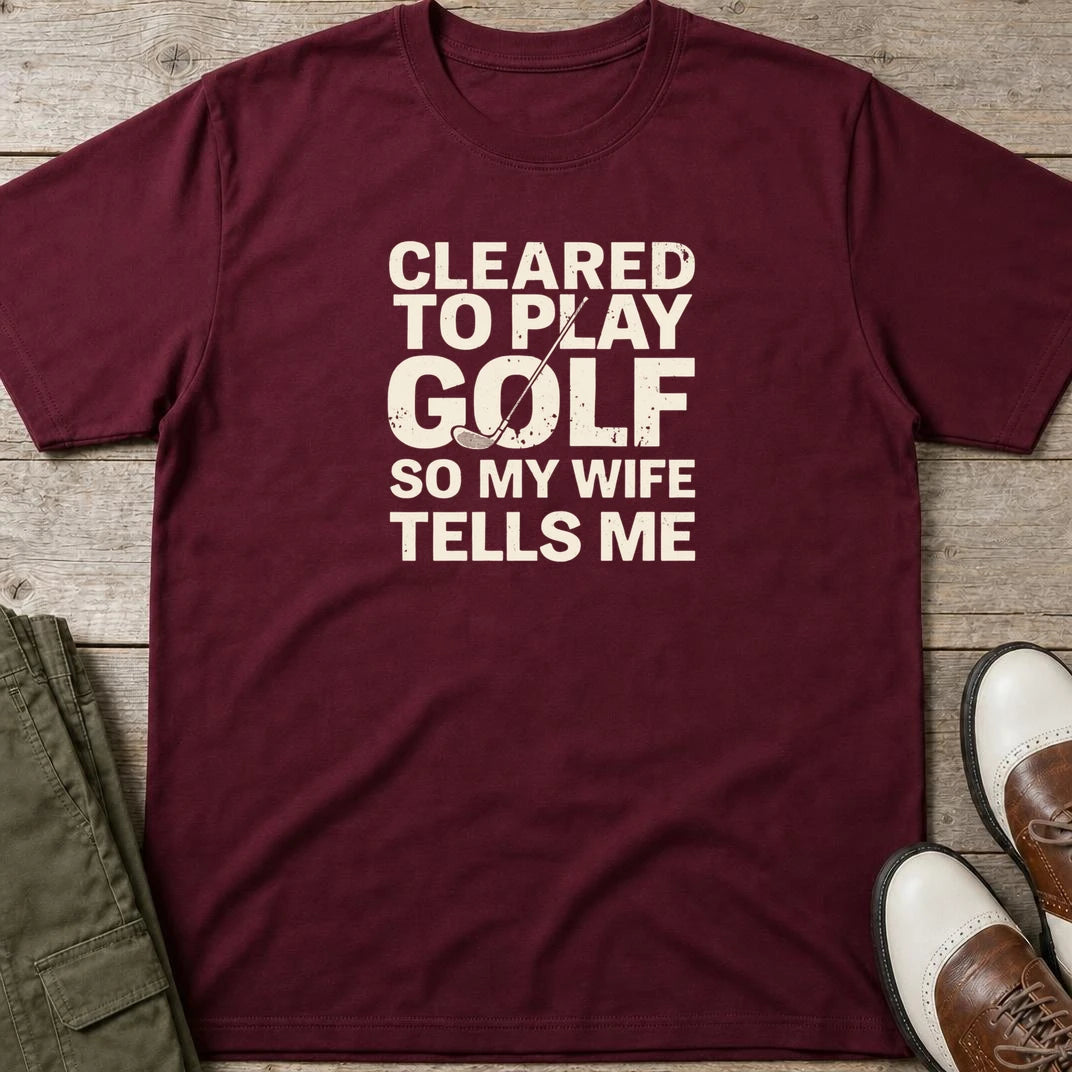Cleared T-Shirt in Maroon lying on a plain floor. T-shirt is a unisex cut and 100 per cent cotton.