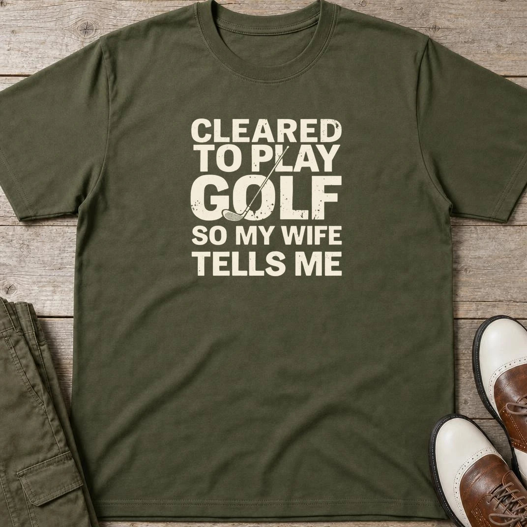 Cleared T-Shirt in Military Green lying on a plain floor. T-shirt is a unisex cut and 100 per cent cotton.