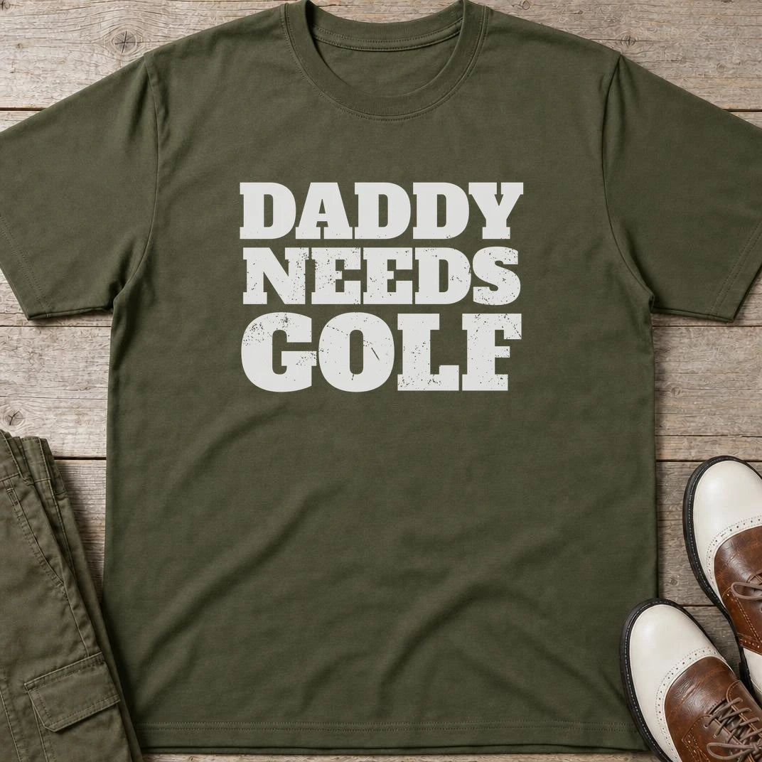Daddy Needs Golf T-Shirt in Military Green lying on a plain floor. T-shirt is a unisex cut and 100 per cent cotton.
