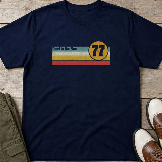 Duel Sun T-Shirt in Navy lying on a plain floor. T-shirt is a unisex cut and 100 per cent cotton.