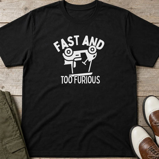 Too Furious T-Shirt in Black lying on a plain floor. T-shirt is a unisex cut and 100 per cent cotton.