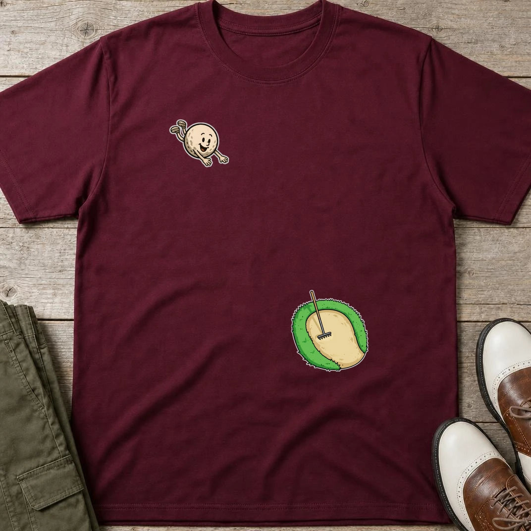 Flying Sand Trap T-Shirt in Maroon lying on a plain floor. T-shirt is a unisex cut and 100 per cent cotton.