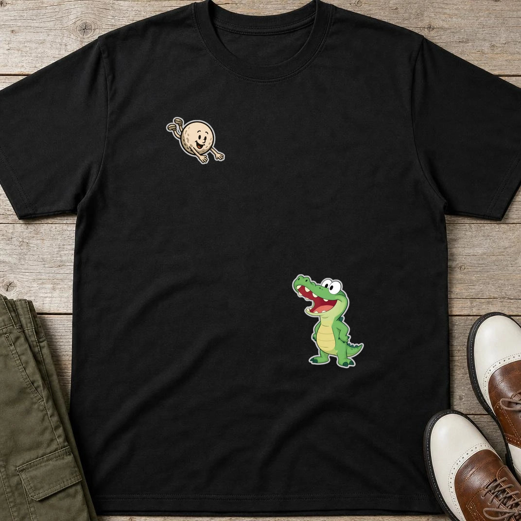 Flying Golf Croc T-Shirt in Black lying on a plain floor. T-shirt is a unisex cut and 100 per cent cotton.