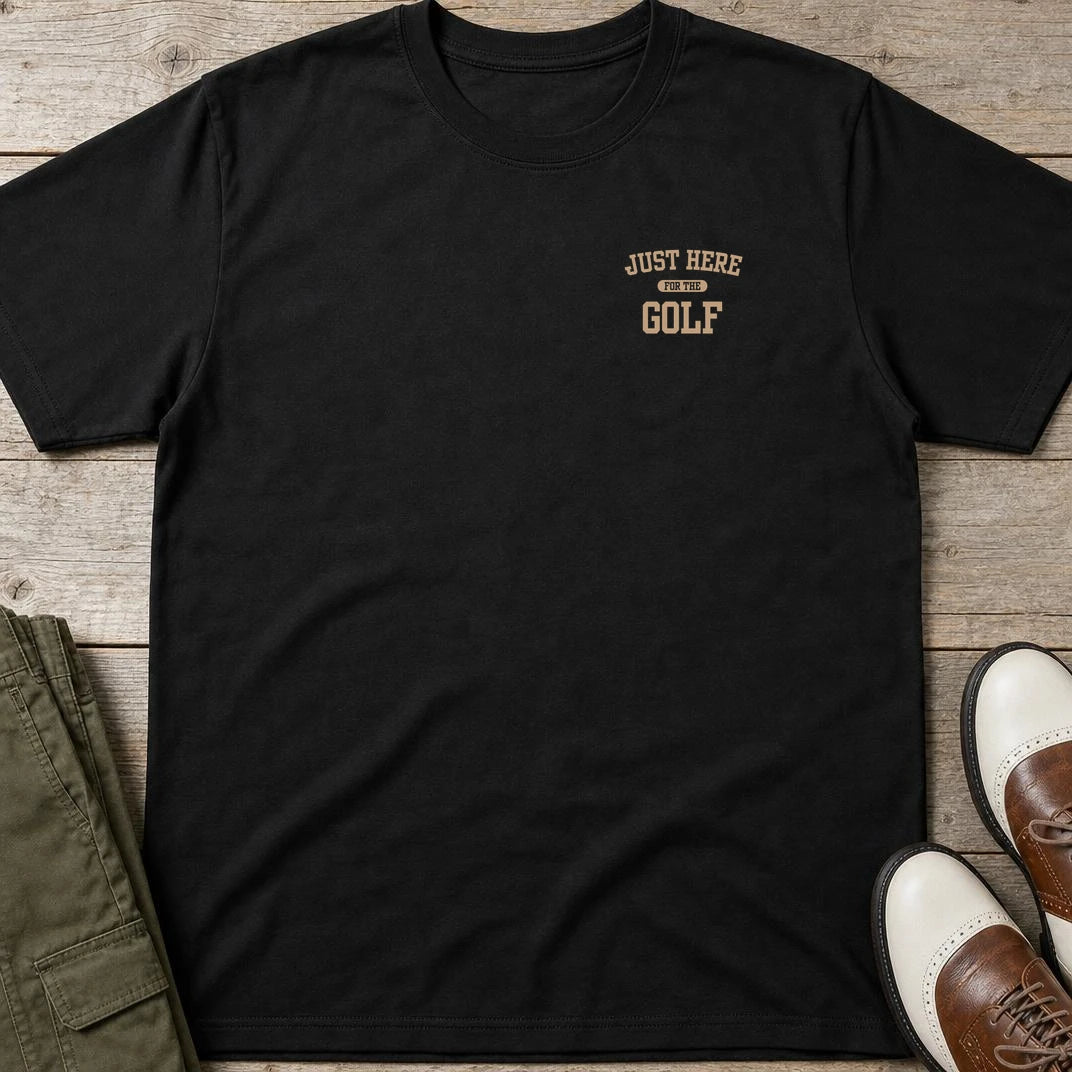 For The Golf Pocket T-Shirt in Black lying on a plain floor. T-shirt is a unisex cut and 100 per cent cotton.