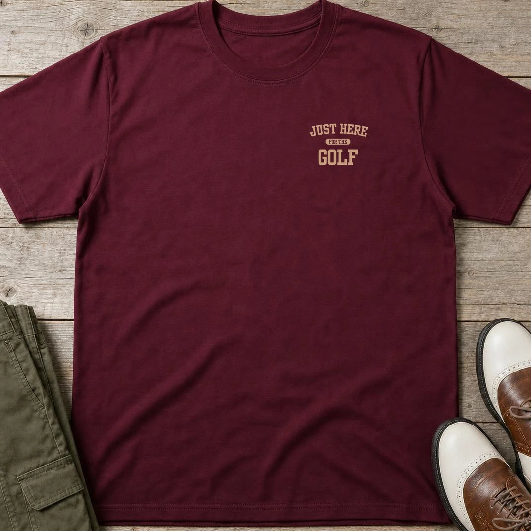 For The Golf Pocket T-Shirt in Maroon lying on a plain floor. T-shirt is a unisex cut and 100 per cent cotton.