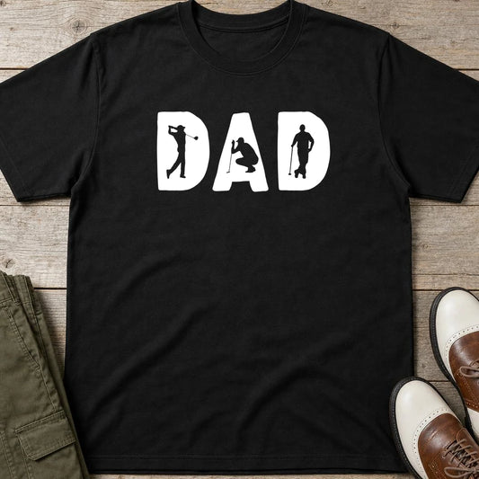 Golf Dad T-Shirt in Black lying on a plain floor. T-shirt is a unisex cut and 100 per cent cotton.